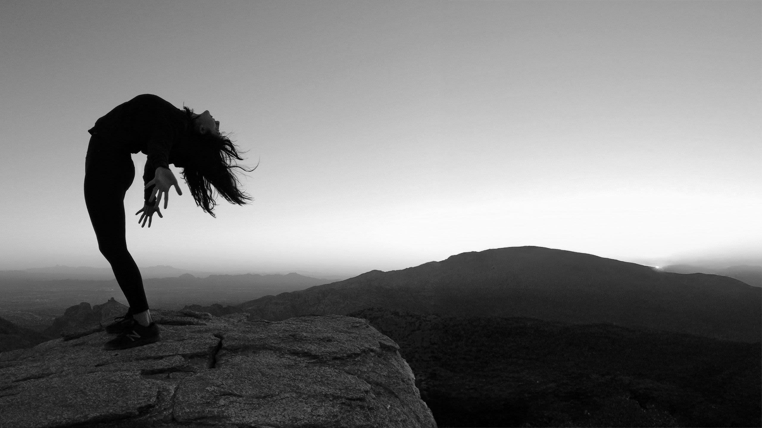 neda in a backbend on a mountain top at sunset