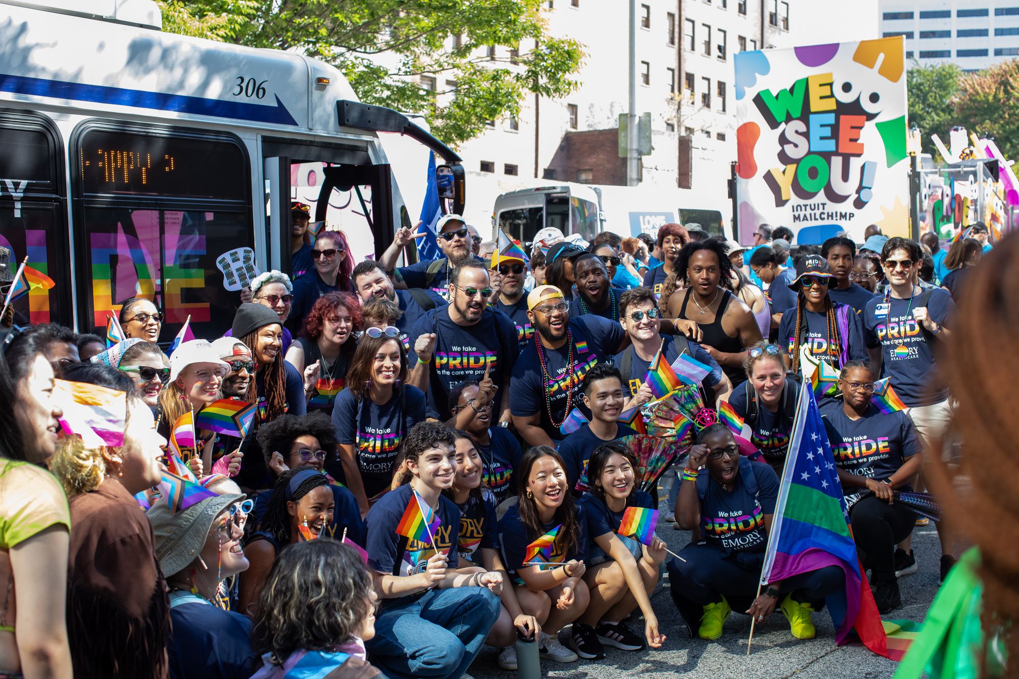 group photo of emory volunteers in front of the emory bus