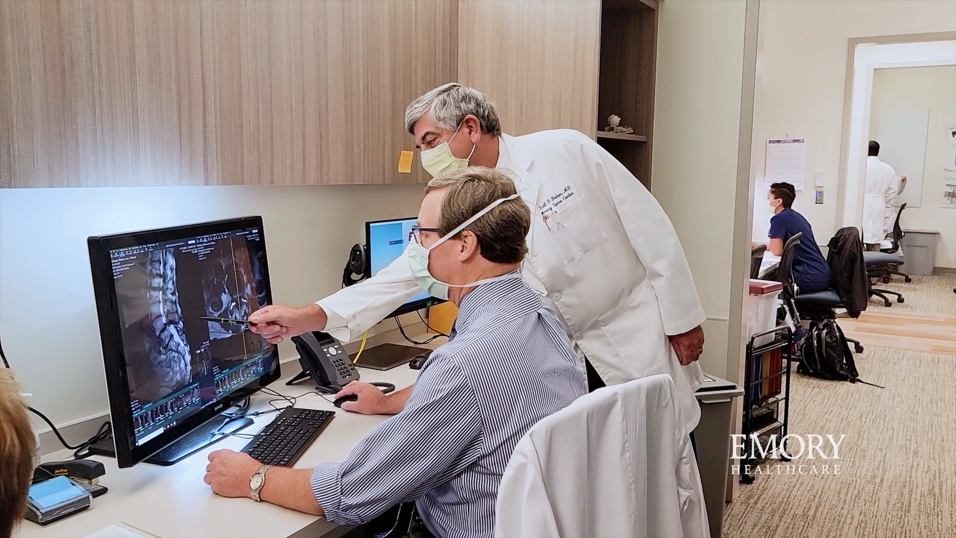 Doctors looking at an X-ray of Carol's spine