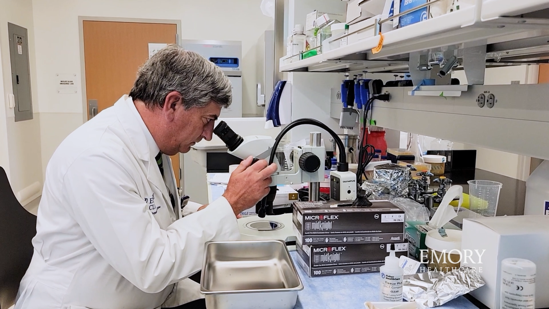 Dr Boden looking into a microscope
