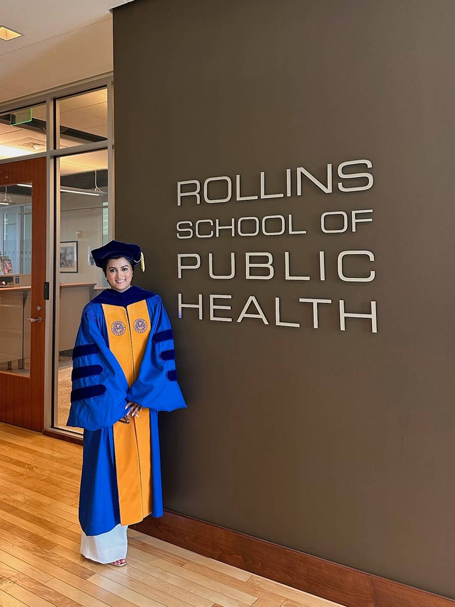 Priya at Rollins School of Public Health in her graduation cap and gown