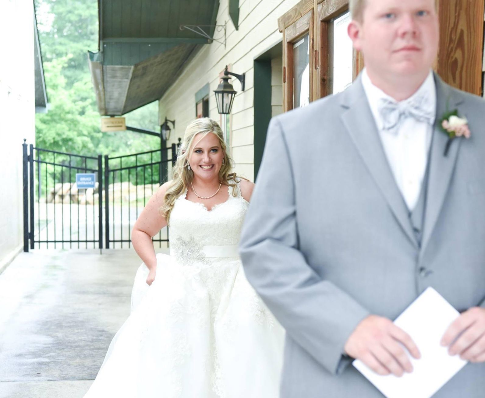 Megan in a photo at her wedding about to surprise her groom